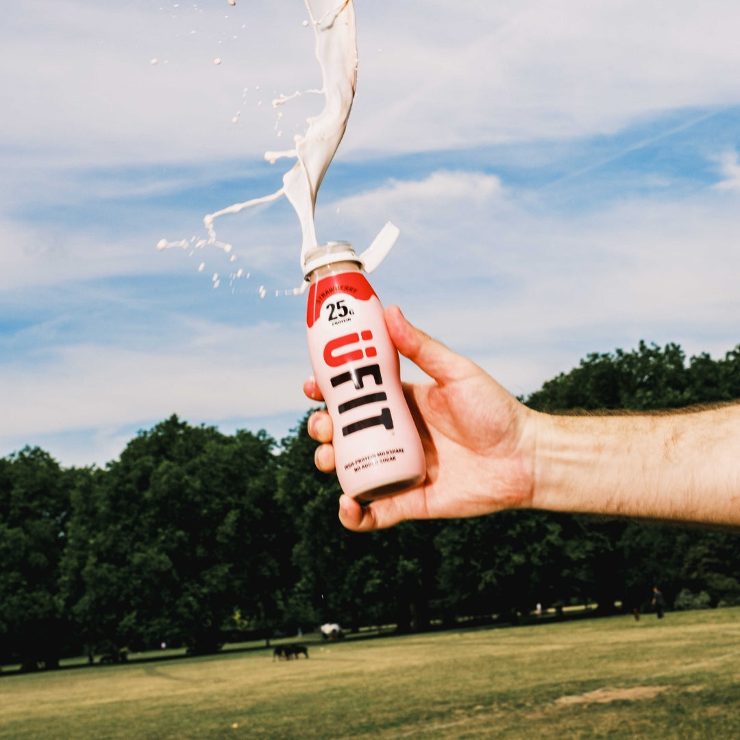 Person holding a 'UFIT' bottle